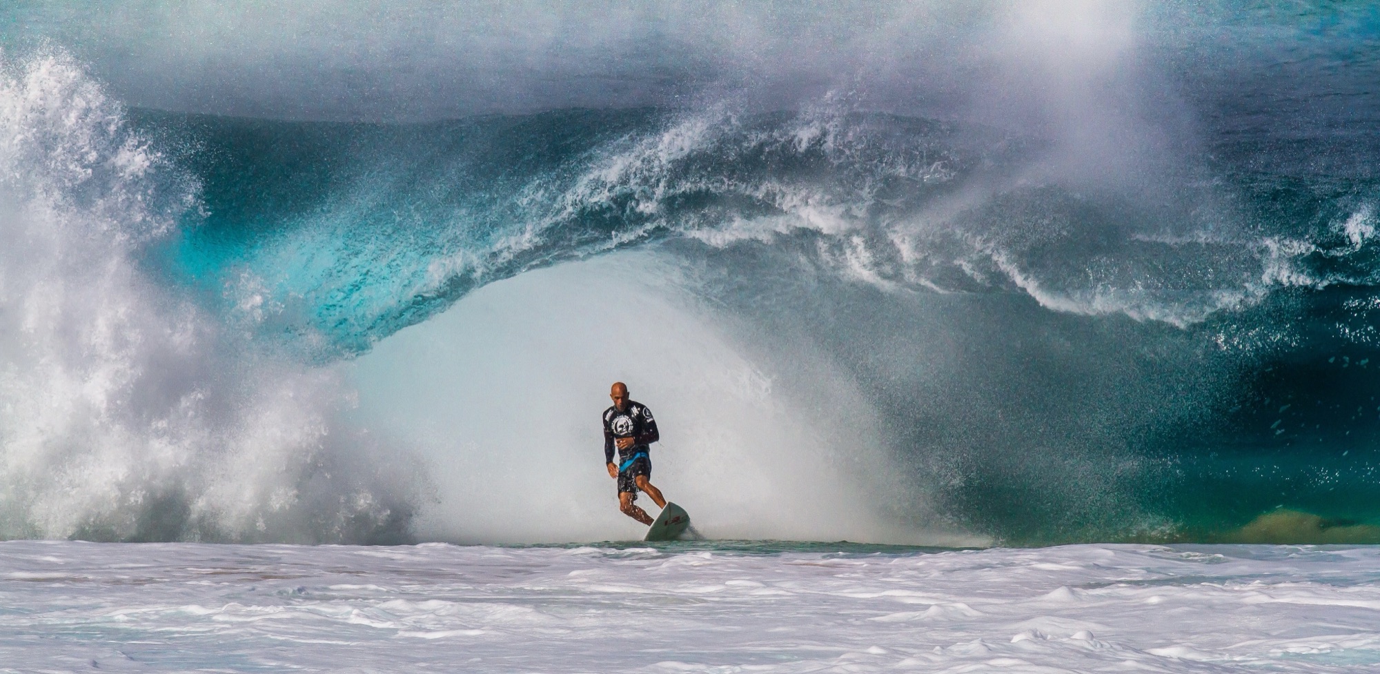 A surfer escaping the barrel of a Banzai Pipeline wave
